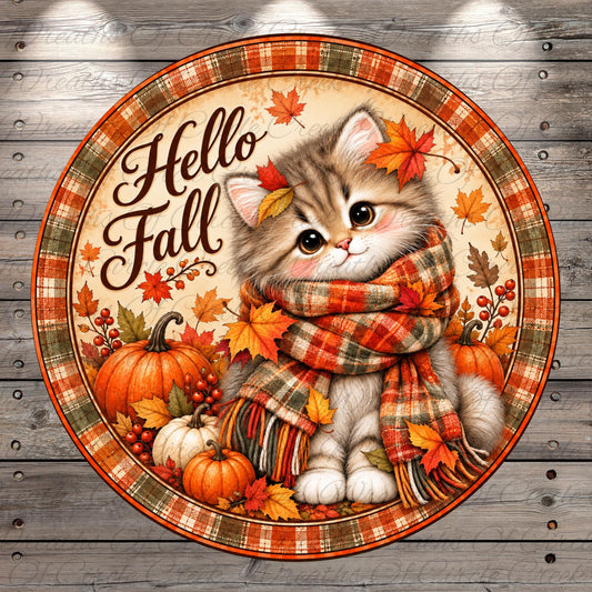 A cute kitten wearing a plaid scarf and surrounded by autumn leaves, pumpkins, and a "Hello Fall" sign.