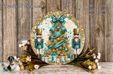 a festive Christmas wreath with a nutcracker soldier and a Christmas tree adorned with ornaments and a ribbon. The wreath is displayed on a wooden surface, surrounded by flowers and other holiday decorations.