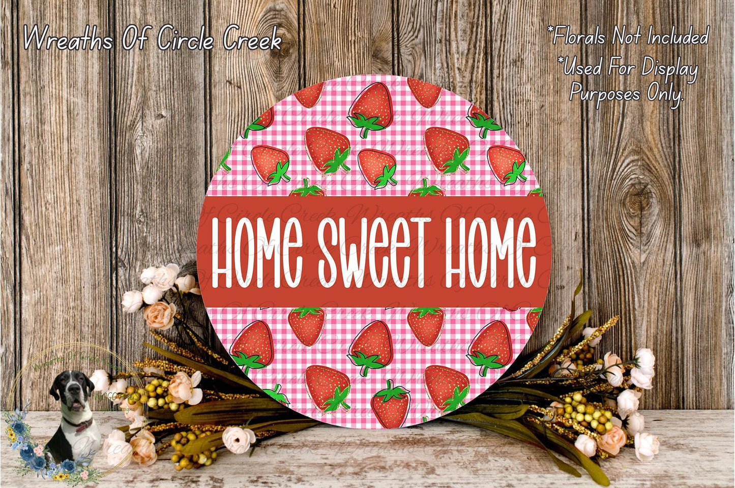 a round sign with the text "HOME SWEET HOME" in bold letters, surrounded by a floral arrangement of flowers and greenery.