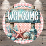 A circular wooden sign with the word "WELCOME" written on it, surrounded by various seashells, starfish, and a lantern.