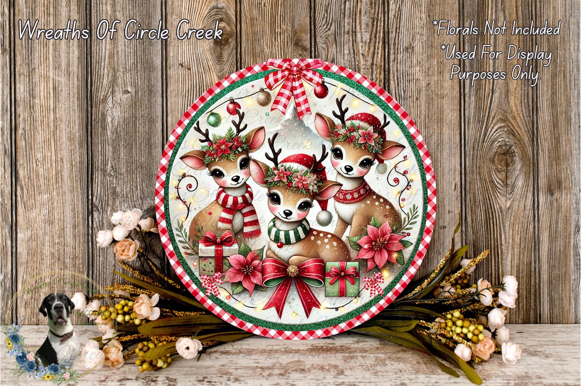 A festive holiday scene featuring three deer wearing Christmas hats and scarves, surrounded by a wreath of flowers and presents, all set against a rustic wooden background.