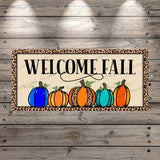 a welcome sign with pumpkins and leopard print