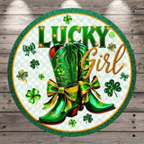 a pair of green cowboy boots with gold bows, surrounded by green shamrocks and the text "Lucky Girl" in a circular design.