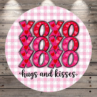 A circular design with the text "XOXO XOXO XOXO hugs and kisses" written in a cursive font.