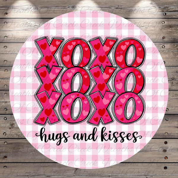 A circular design with the text "XOXO XOXO XOXO hugs and kisses" written in a cursive font.