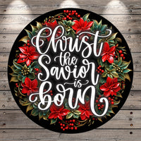 A circular wreath with red poinsettia flowers and greenery surrounding a message that reads &quot;Christ the Saviour is born&quot;.