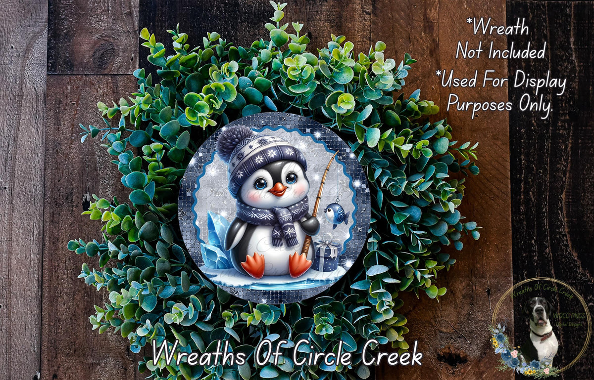 A wreath featuring a cute penguin wearing a hat and scarf, surrounded by a lush green plant.