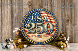 a circular sign with the text "USA 250" and "1776 2026" on it, surrounded by a wreath of flowers and a wooden background.