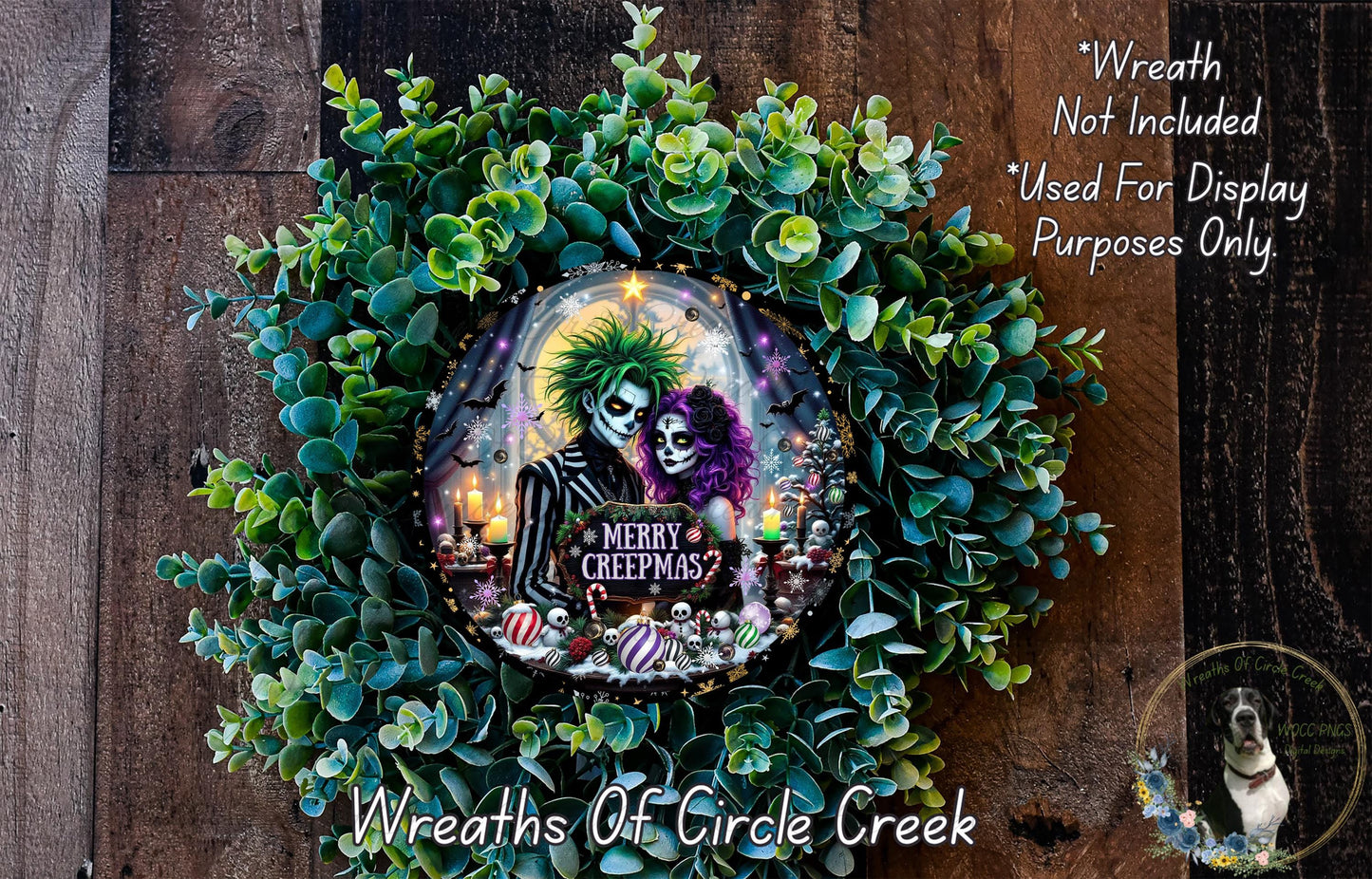 A wreath made of green leaves and featuring a couple with spooky makeup and costumes, surrounded by a "Merry CreepMAS?" sign.