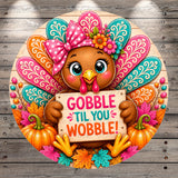 A cheerful cartoon turkey holding a sign that says "GOBBLE TIL YOU WOBBLE!" surrounded by autumn leaves, pumpkins, and other festive decorations.