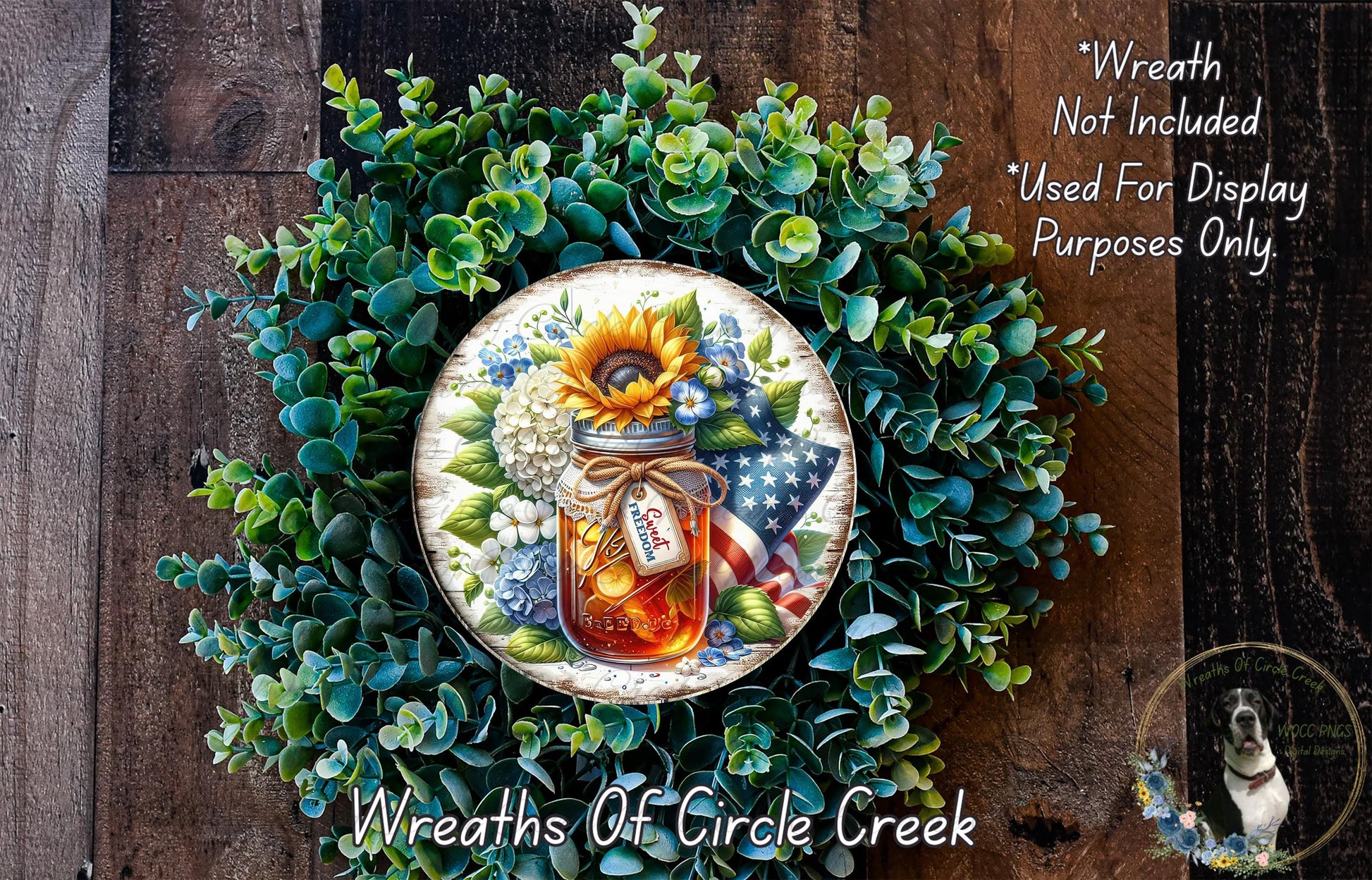 a wreath made of various green plants and a jar of honey, with a sunflower and an American flag displayed on the wreath.
