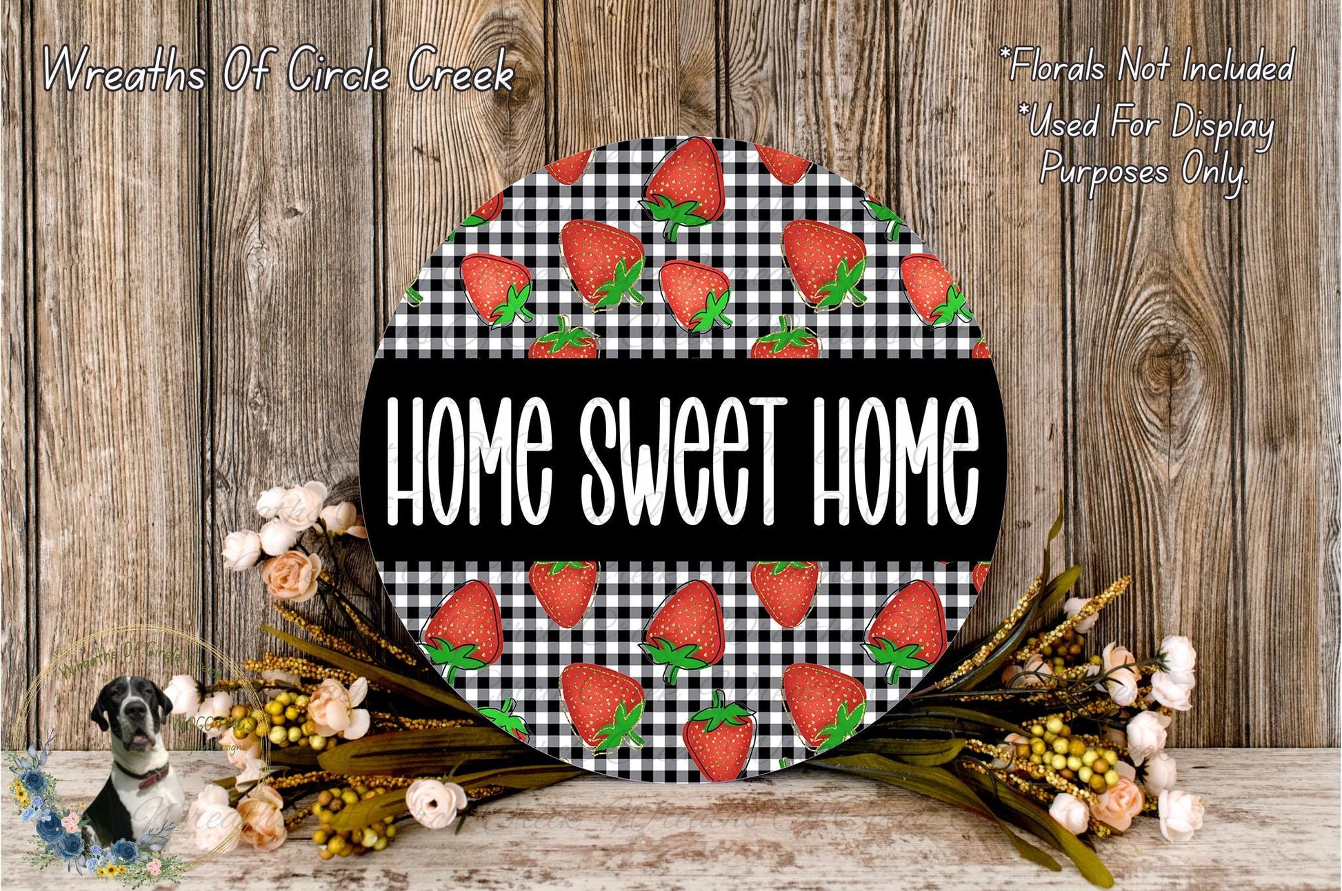 a round sign with the text "HOME SWEET HOME" displayed prominently in the center. The sign is surrounded by a floral arrangement of flowers and greenery, creating a warm and inviting atmosphere.