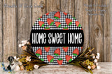 a round sign with the text "HOME SWEET HOME" displayed prominently in the center. The sign is surrounded by a floral arrangement of flowers and greenery, creating a warm and inviting atmosphere.