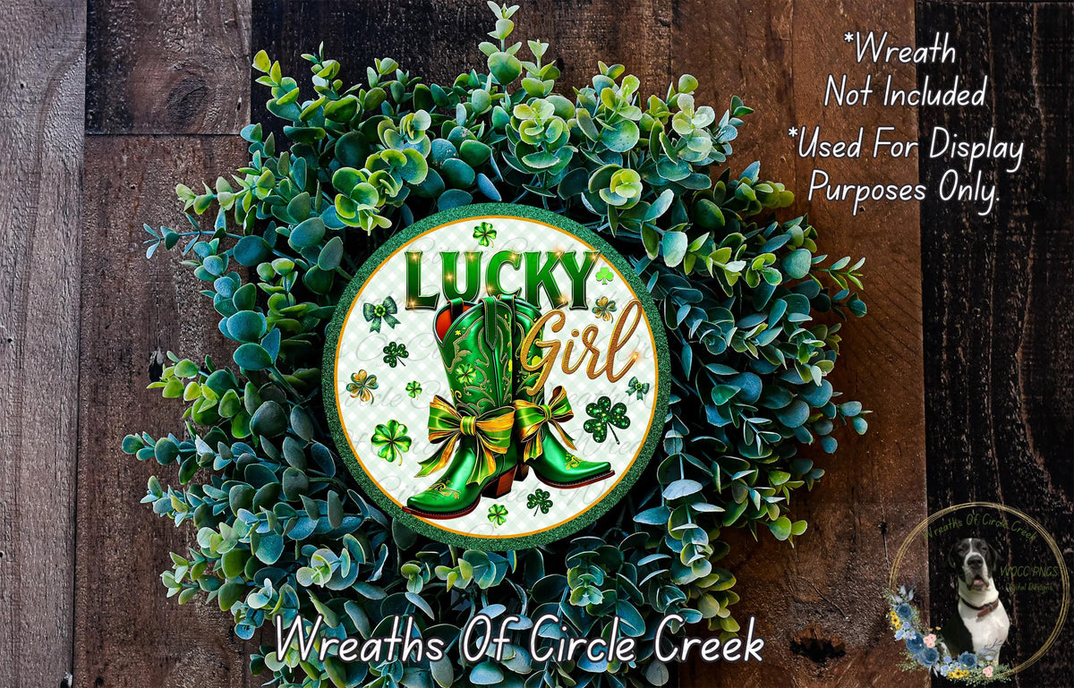 a wreath with the text "Lucky Girl" and a pair of green boots, surrounded by greenery.