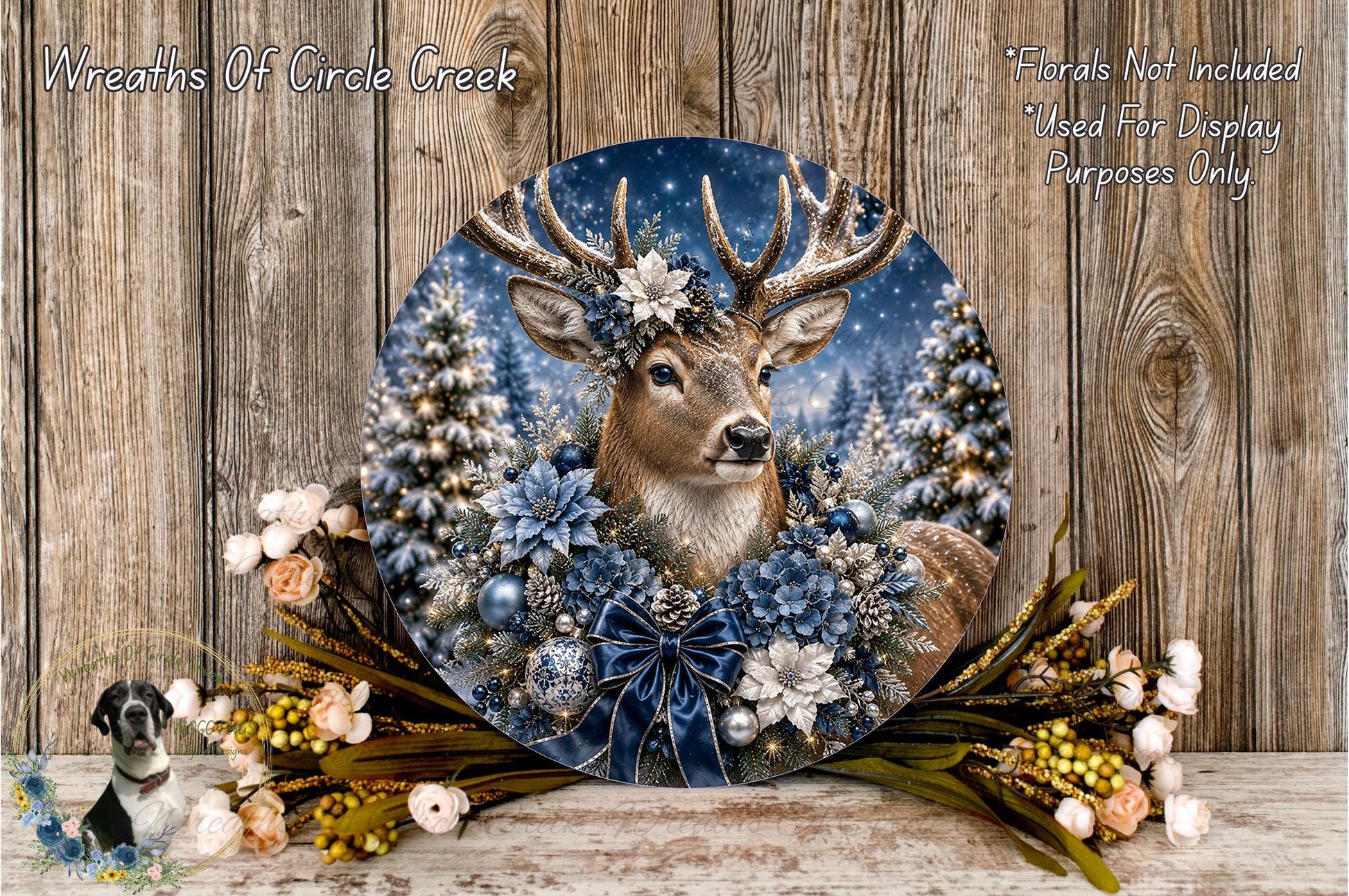 A decorative wreath featuring a deer head surrounded by flowers and greenery, set against a snowy winter landscape.