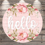 A circular floral design with the word "Hello" written in cursive script, surrounded by pink flowers and green leaves.