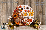 A decorative sign featuring a goose wearing sunglasses and surrounded by autumn-themed elements such as sunflowers, pumpkins, and leaves. The sign has the text "My Porch Goose Runs This House" and is displayed on a wooden surface.