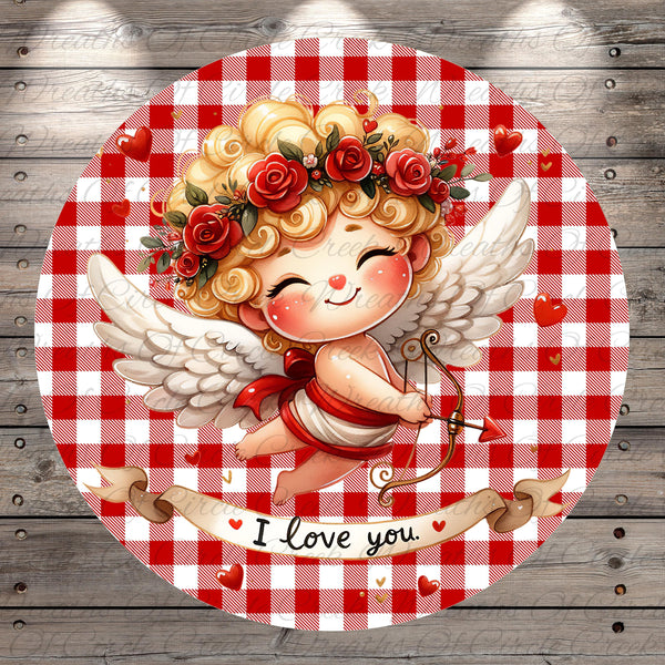 A cheerful illustration of a cherub-like figure with curly hair, wings, and a flower crown, holding a bow and arrow, set against a red and white checkered background with the text "I love you" below.