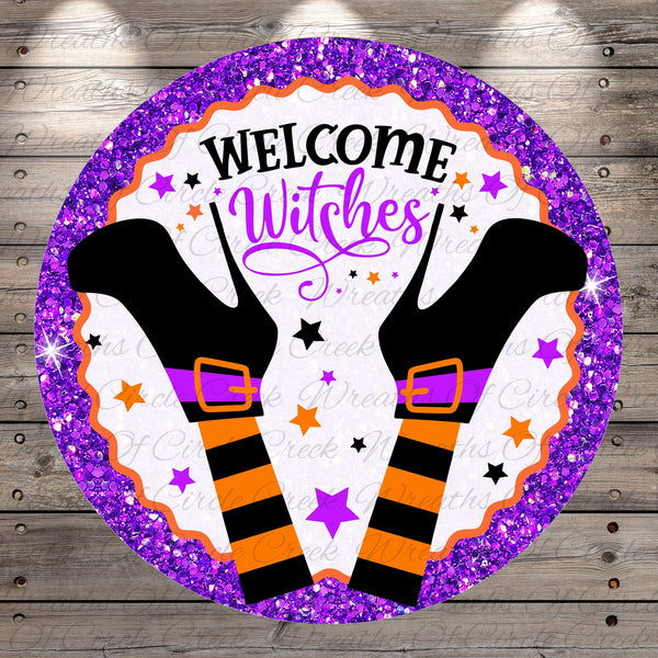 A round sign with a purple border and glittery background, featuring a pair of witch's boots and the text "Welcome Witches" in a stylized font.