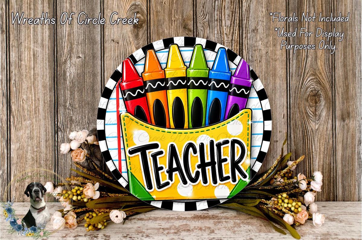 A colorful sign with the word "TEACHER" displayed prominently, surrounded by crayons and flowers.