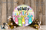 a colorful Easter-themed sign with the text "HOWDY PEEPS" and illustrations of cartoon rabbits. The sign is surrounded by a floral arrangement and placed on a wooden surface.