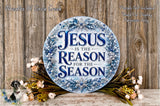 a circular sign with the text "JESUS IS THE REASON FOR THE SEASON" surrounded by a wreath of flowers and greenery.