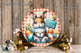 A round, decorative plate featuring a cartoon rabbit holding a sign that says "Happy Easter" surrounded by Easter eggs, flowers, and a bird.