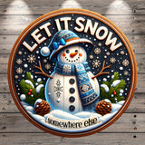 A snowman wearing a blue hat and scarf, surrounded by pine cones, snowflakes, and pine trees, with the text "LET IT SNOW somewhere else" displayed on a circular sign.