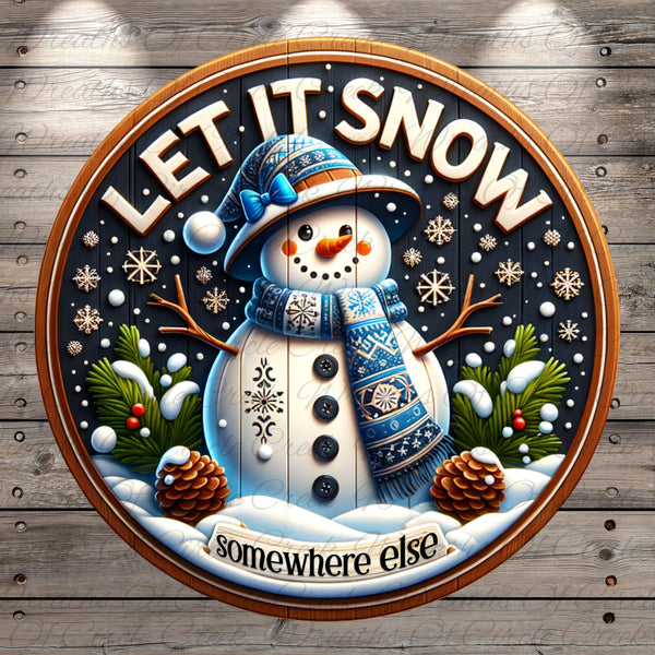 A snowman wearing a blue hat and scarf, surrounded by pine cones, snowflakes, and pine trees, with the text "LET IT SNOW somewhere else" displayed on a circular sign.