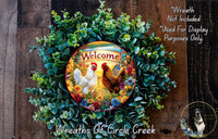 a wreath with a welcoming message, surrounded by greenery and flowers. The wreath is displayed on a wooden surface, and there is a small dog in the bottom right corner.