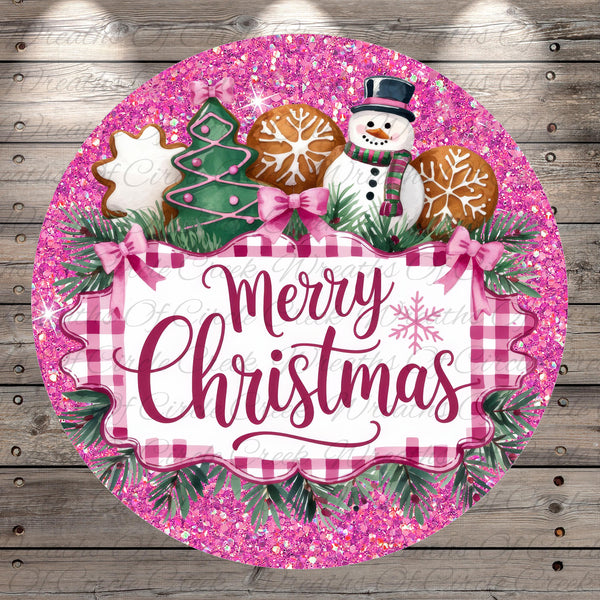 A festive Christmas-themed round sign with a pink and white checkered border, surrounded by a glittery pink background. The sign features a snowman, gingerbread cookies, and a "Merry Christmas" message.