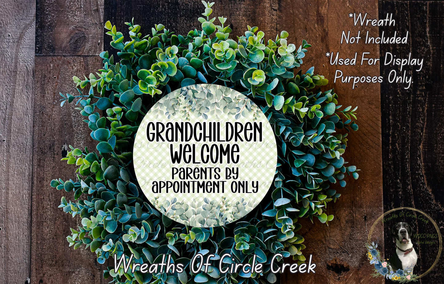 a wreath made of green leaves and flowers, with a sign that reads "Grandchildren Welcome by appointment only" in the center.