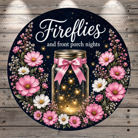 A round sign with a black background and a floral border, featuring a jar with a pink ribbon and a light inside, surrounded by pink and white flowers.