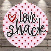 A circular design with the text "I Love Shack" written in a stylized font, surrounded by a pattern of red hearts on a pink background.