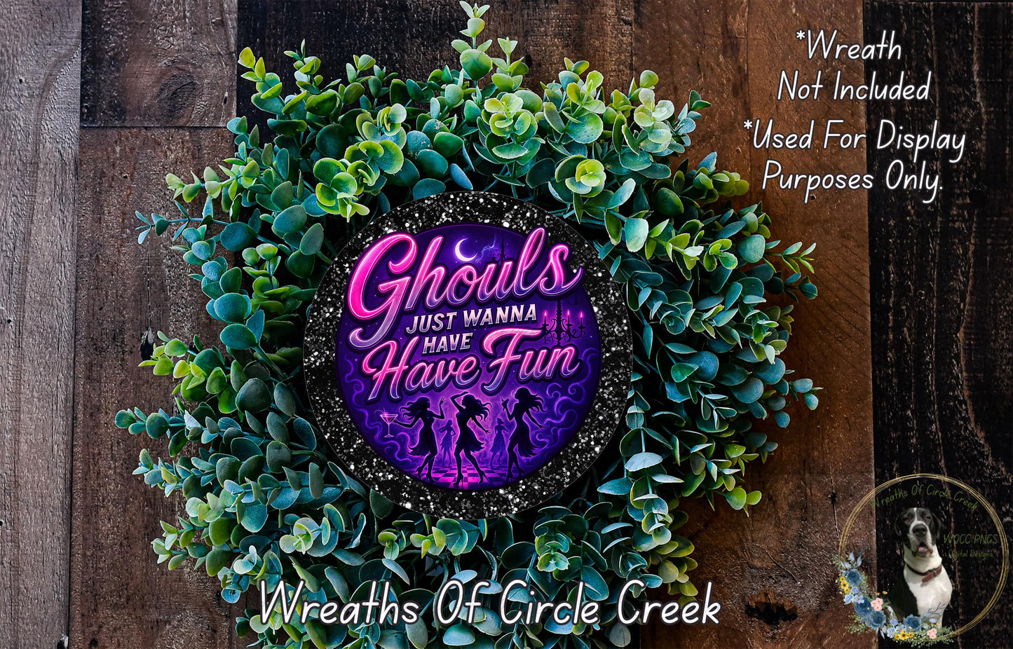 a wreath made of green plants and a purple circular design with text on it, placed on a wooden surface.