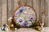 A wooden sign with a dragonfly and flowers, surrounded by a floral arrangement, against a wooden background.