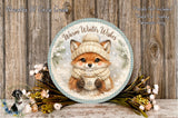 A decorative plate featuring a fox wearing a winter hat and scarf, holding a cup of tea, surrounded by flowers and a wreath.