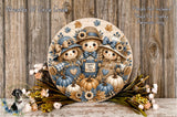 A decorative wreath featuring three scarecrow figures surrounded by autumn-themed elements such as pumpkins, flowers, and leaves. The wreath is displayed on a wooden surface, with a floral arrangement and a small bird figurine nearby.