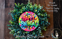 a colorful birthday wreath made of green leaves and colorful balls, with the text "Happy Birthday" displayed prominently in the center.