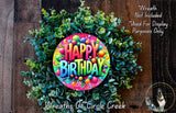 a colorful birthday wreath made of green leaves and colorful balls, with the text "Happy Birthday" displayed prominently in the center.