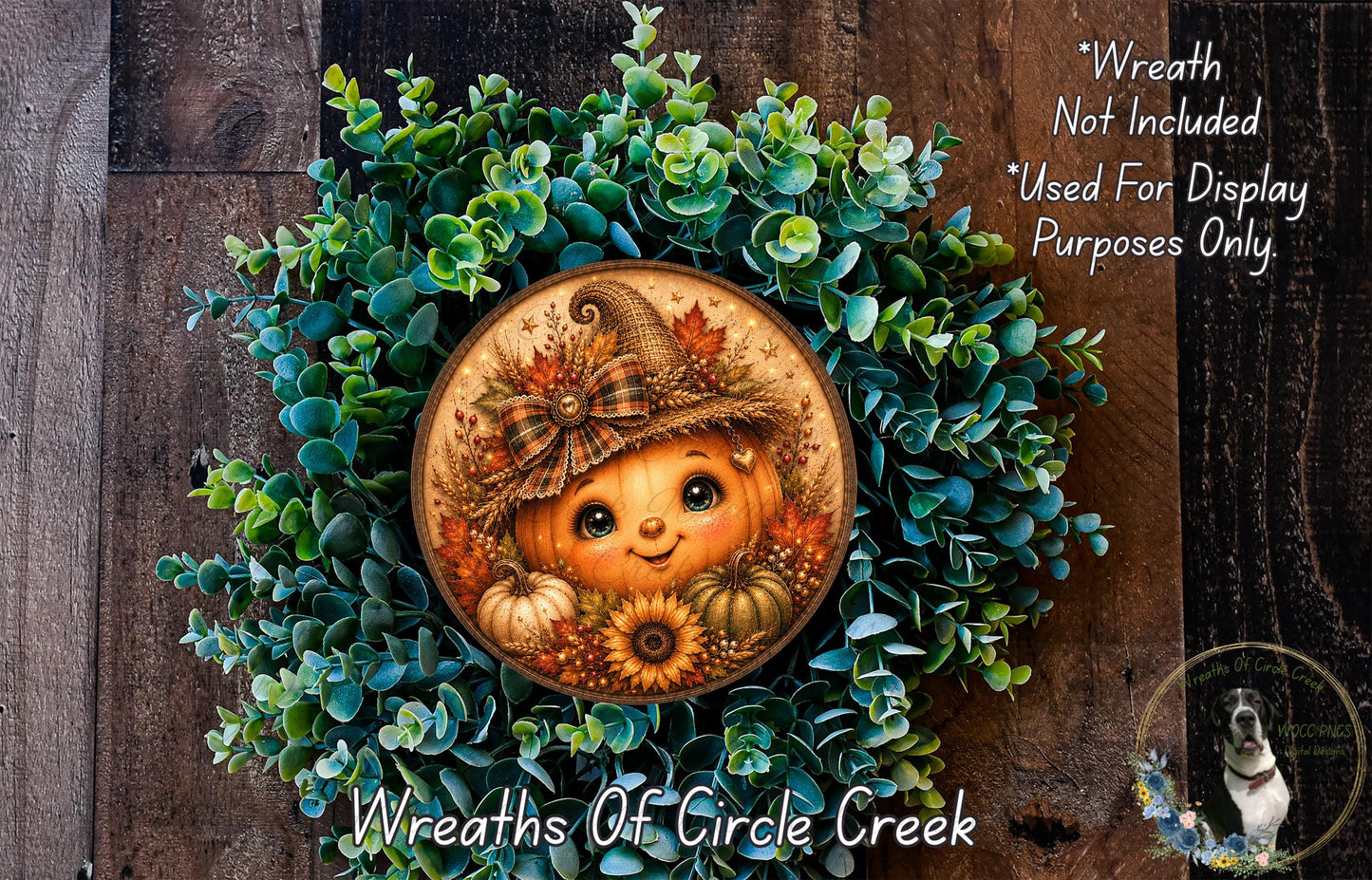 A wreath featuring a pumpkin and sunflowers, with a smiling face, is displayed on a wooden surface.