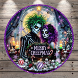 The image is a Halloween-themed collage featuring a couple dressed in spooky costumes, surrounded by various Halloween-related elements such as bats, skulls, snowflakes, and candy canes. The text "MERRY CREEPMAS" is prominently displayed in the center of the collage.