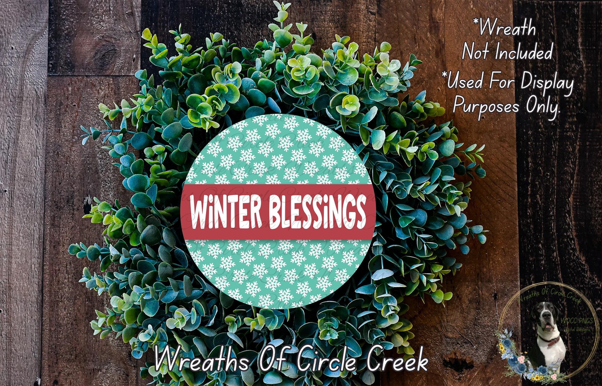 A wreath made of green leaves and flowers, with a red and white circular sign that says "Winter Blessings" in the center.