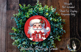 A wreath featuring a Santa Claus figure holding a gift box, surrounded by a lush green plant.