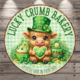 A cartoon pig wearing a green hat and holding a heart-shaped cookie, surrounded by various festive elements such as a cupcake, a cake, and shamrocks, with the text "Lucky Crumb Bakery" and "A little luck in every bite" displayed around the image.