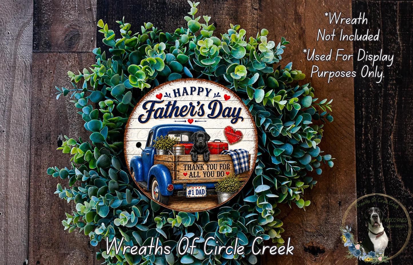 A wreath made of green leaves and a blue truck with a dog in the bed, celebrating Father's Day.