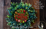 A festive Christmas wreath made of evergreen branches, adorned with ornaments and a "Merry Christmas" sign. The wreath is displayed on a wooden surface, and there is a small dog in the bottom right corner.