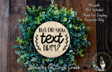 a wreath made of green succulents and a wooden sign with the text "But did you text first?" displayed on it.