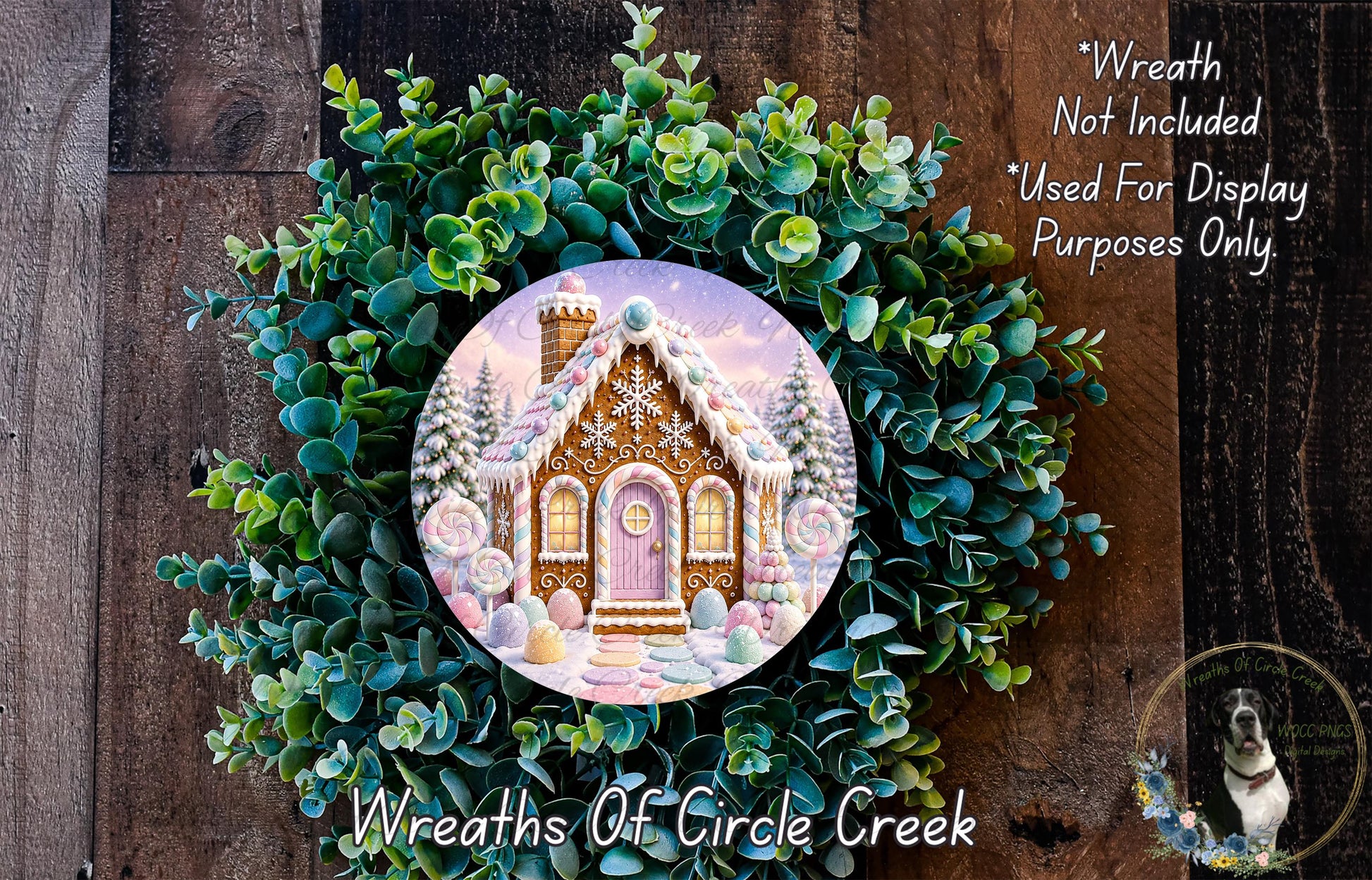 A wreath featuring a gingerbread house surrounded by greenery, with a caption stating that the wreath is not included in a display and is used for purposes only.