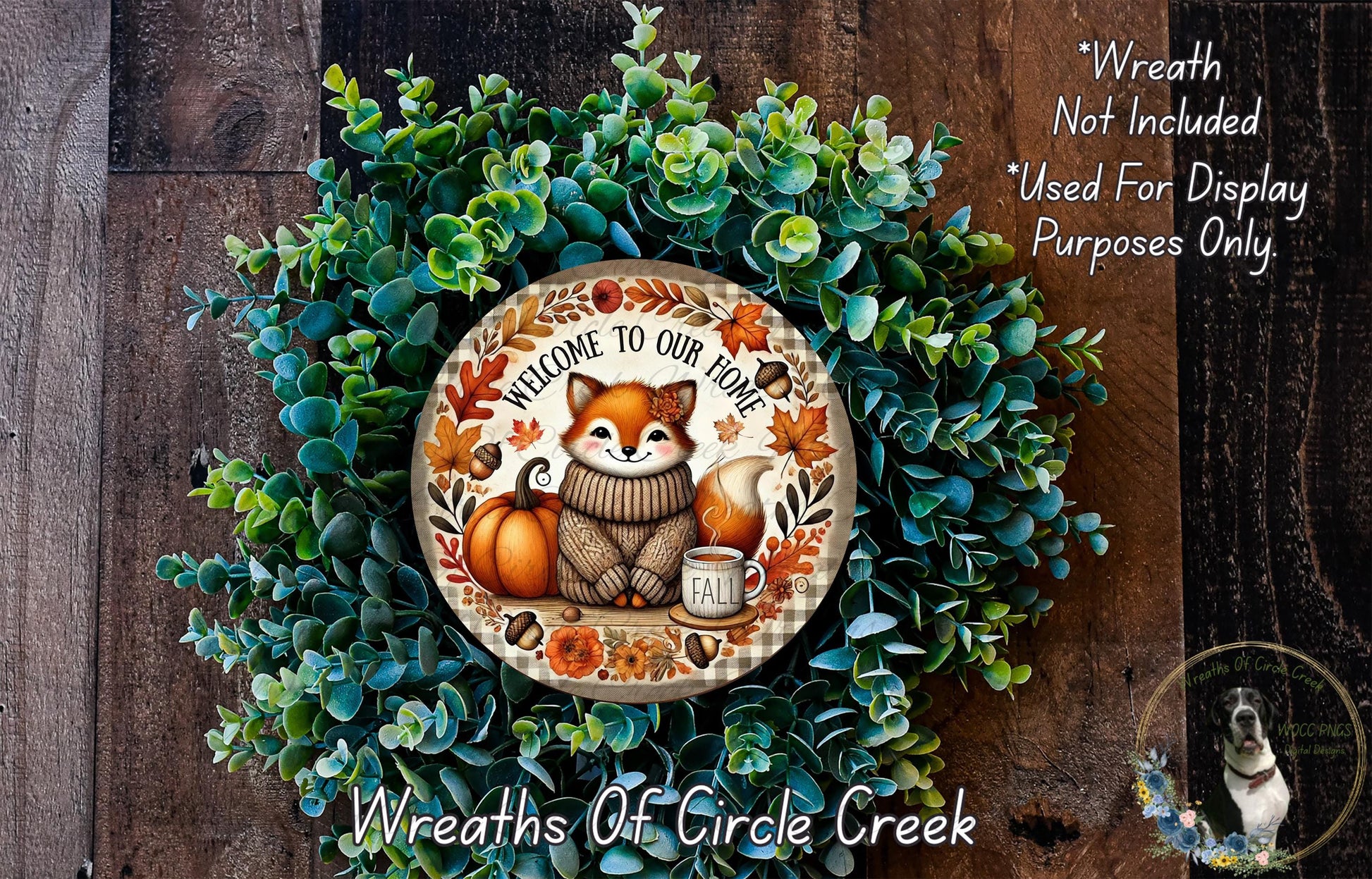 a wreath with a fox wearing a sweater and holding a cup of fall leaves, surrounded by a lush green wreath. The wreath is displayed on a wooden surface, and there is a text overlay that reads "Welcome to Our Home" and "Wreath Not Included Used For Display Purposes Only".